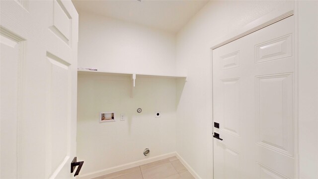 2227 Stoneman St, Dallas, TX 75215 - laundry room with hookup for a washing machine, hookup for a gas dryer, hookup for an electric dryer, light tile patterned floors, and baseboards