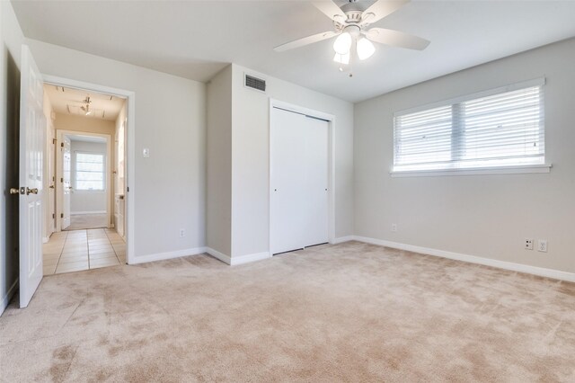 2645 Woodmere Dr, Dallas, TX 75233 - unfurnished bedroom featuring visible vents, attic access, light carpet, light tile patterned floors, and a closet