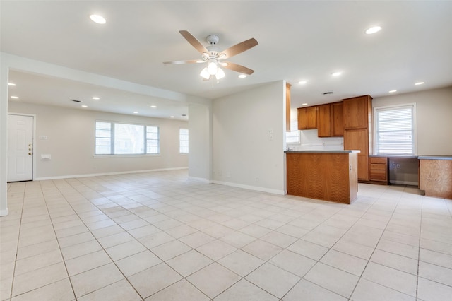 2645 Woodmere Dr, Dallas, TX 75233 - kitchen featuring light tile patterned floors, brown cabinetry, open floor plan, and ceiling fan
