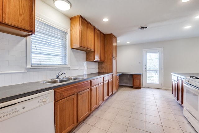 2645 Woodmere Dr, Dallas, TX 75233 - kitchen with visible vents, brown cabinets, a sink, white appliances, and light tile patterned floors