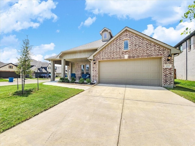 view of front of property featuring a front yard, an attached garage, brick siding, and driveway