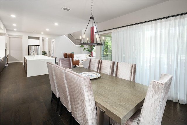 dining area with dark wood-style flooring, an inviting chandelier, stairs, recessed lighting, and visible vents