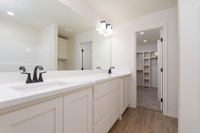 5557 N 10th, Abilene, TX 79601 - full bathroom featuring double vanity, wood finished floors, recessed lighting, and a spacious closet
