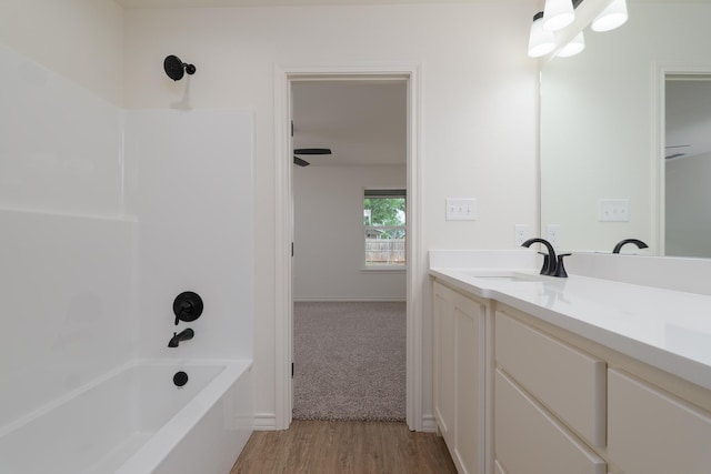 5557 N 10th, Abilene, TX 79601 - full bath featuring bathtub / shower combination, vanity, wood finished floors, and baseboards