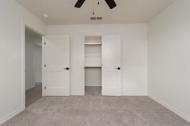 5557 N 10th, Abilene, TX 79601 - unfurnished bedroom with carpet, a spacious closet, baseboards, a ceiling fan, and a closet