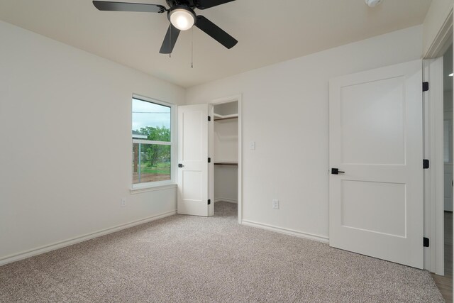 5557 N 10th, Abilene, TX 79601 - unfurnished bedroom with carpet floors, baseboards, a spacious closet, and a ceiling fan