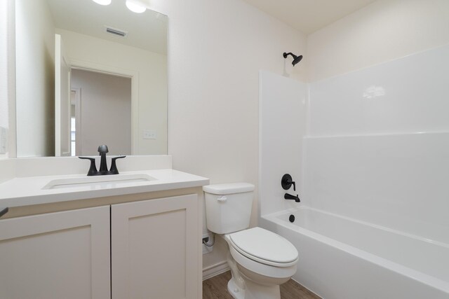 5557 N 10th, Abilene, TX 79601 - full bathroom featuring toilet, wood finished floors, vanity, and shower / tub combination