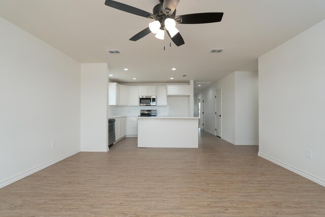 5557 N 10th, Abilene, TX 79601 - unfurnished living room with light wood finished floors, baseboards, recessed lighting, and ceiling fan