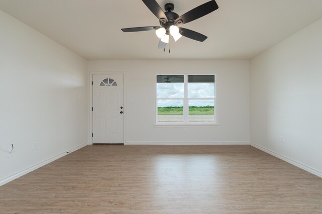 5557 N 10th, Abilene, TX 79601 - spare room featuring ceiling fan, light wood-style flooring, and baseboards