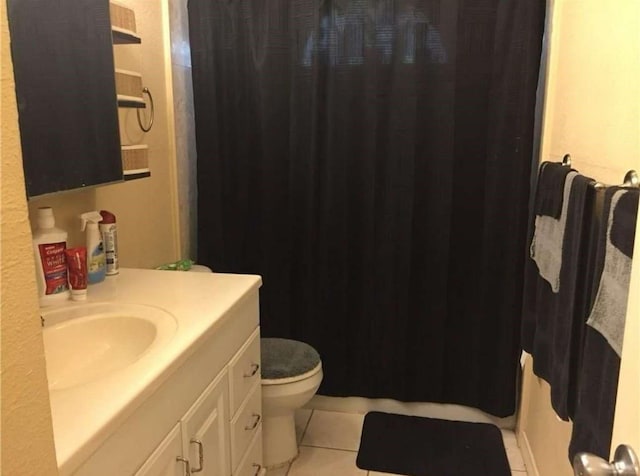 bathroom with tile patterned floors, toilet, vanity, and a shower with curtain
