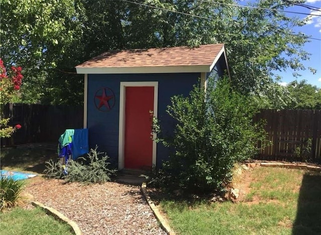 view of shed with fence