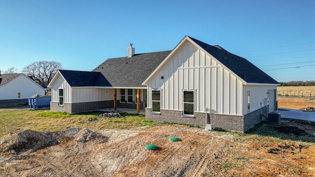 JarTBD Leo Lane, Poolville, TX 76487 - rear view of house featuring brick siding, cooling unit, board and batten siding, and a patio