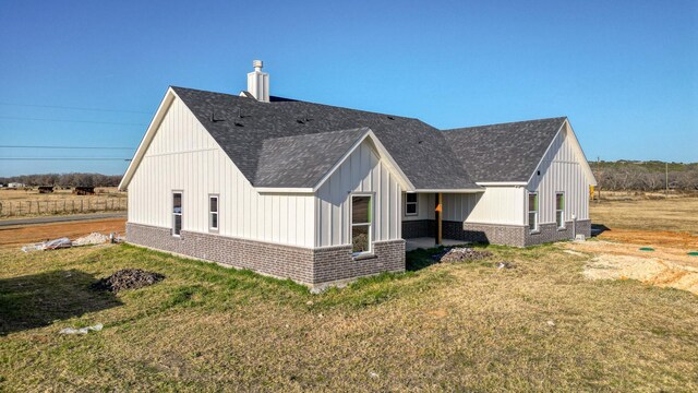 JarTBD Leo Lane, Poolville, TX 76487 - view of side of property featuring a patio, roof with shingles, a yard, a chimney, and brick siding