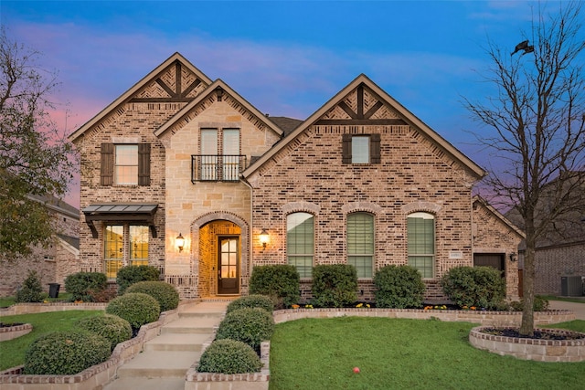 4406 Ravenbank Dr, Rockwall, TX 75087 - view of front of home featuring brick siding, cooling unit, a front lawn, and a balcony