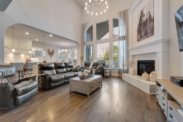 4406 Ravenbank Dr, Rockwall, TX 75087 - living area featuring a fireplace, a notable chandelier, and dark wood-style floors