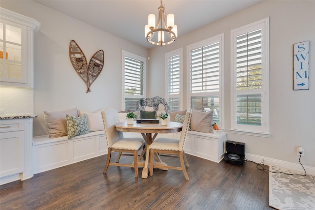4406 Ravenbank Dr, Rockwall, TX 75087 - dining space with an inviting chandelier, dark wood-style floors, and baseboards