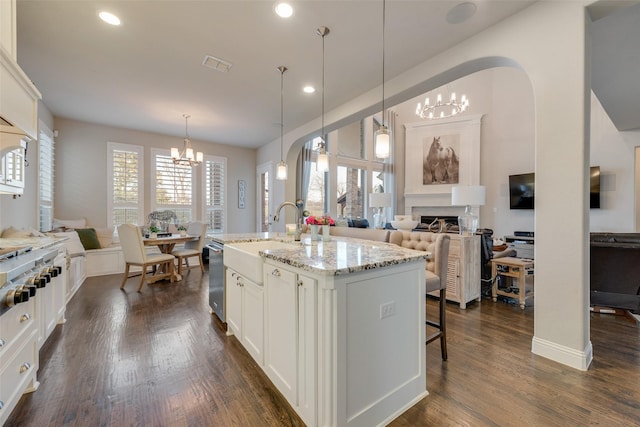 4406 Ravenbank Dr, Rockwall, TX 75087 - kitchen with stainless steel dishwasher, dark wood-type flooring, visible vents, and a chandelier