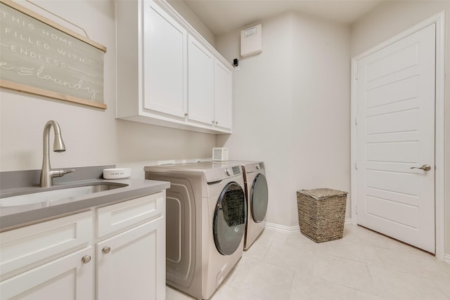 4406 Ravenbank Dr, Rockwall, TX 75087 - laundry room featuring light tile patterned floors, baseboards, cabinet space, a sink, and washing machine and dryer