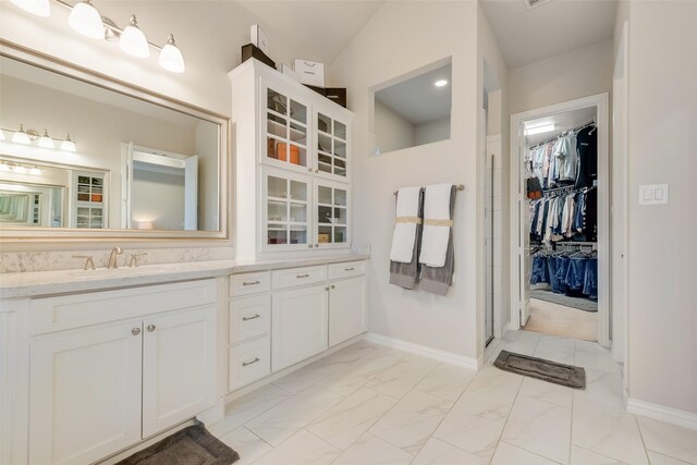 4406 Ravenbank Dr, Rockwall, TX 75087 - bathroom featuring a spacious closet, a shower stall, baseboards, marble finish floor, and vanity