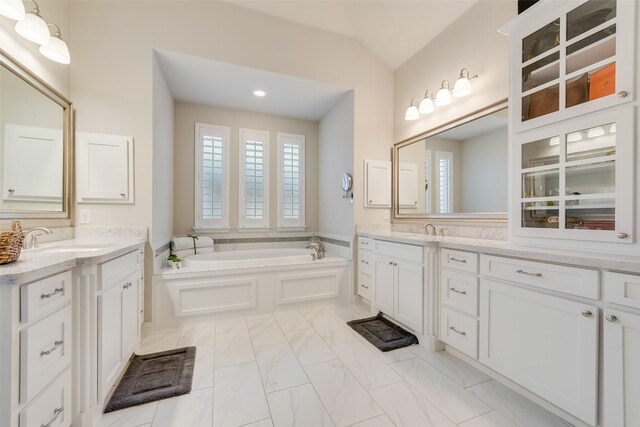 4406 Ravenbank Dr, Rockwall, TX 75087 - bathroom featuring a bath, a sink, two vanities, and vaulted ceiling