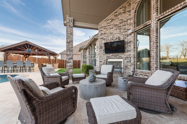 4406 Ravenbank Dr, Rockwall, TX 75087 - view of patio with a gazebo, an outdoor living space with a fireplace, fence, and outdoor dry bar