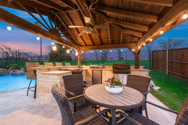 4406 Ravenbank Dr, Rockwall, TX 75087 - patio terrace at dusk featuring a gazebo, area for grilling, a fenced backyard, and outdoor dry bar