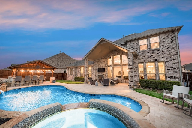 4406 Ravenbank Dr, Rockwall, TX 75087 - view of pool featuring fence, exterior fireplace, a pool with connected hot tub, a patio area, and outdoor dry bar