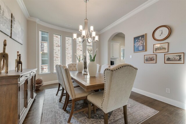 4406 Ravenbank Dr, Rockwall, TX 75087 - dining space with baseboards, dark wood finished floors, arched walkways, crown molding, and a chandelier