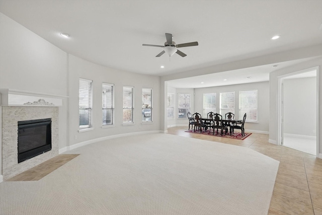 living area with recessed lighting, a fireplace, light tile patterned floors, baseboards, and ceiling fan