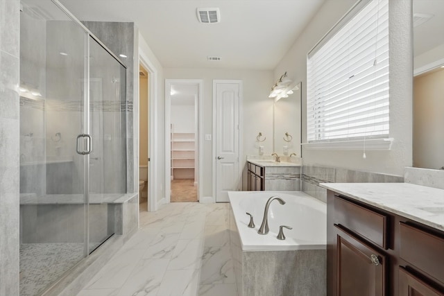 full bath featuring visible vents, a stall shower, a bath, marble finish floor, and vanity
