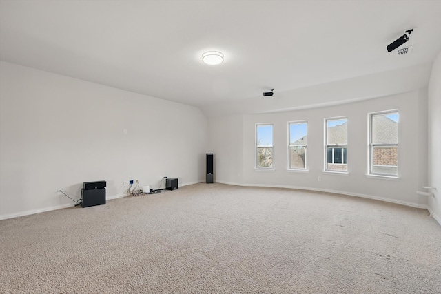 carpeted spare room featuring visible vents and baseboards