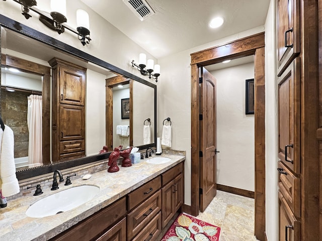 2195 Century Oak Dr, Graford, TX 76449 - bathroom with a sink, visible vents, baseboards, and double vanity