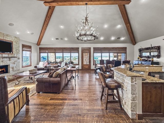 2195 Century Oak Dr, Graford, TX 76449 - living area with beamed ceiling, plenty of natural light, high vaulted ceiling, and a fireplace