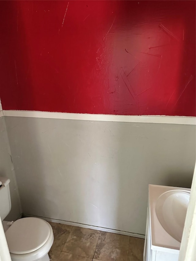 bathroom featuring toilet and vanity