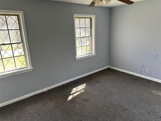 carpeted empty room featuring baseboards, a textured ceiling, and a ceiling fan