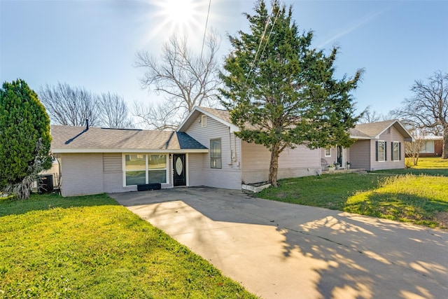 909 Coffield St, Bowie, TX 76230 - view of front of property featuring concrete driveway, brick siding, a front yard, and a shingled roof