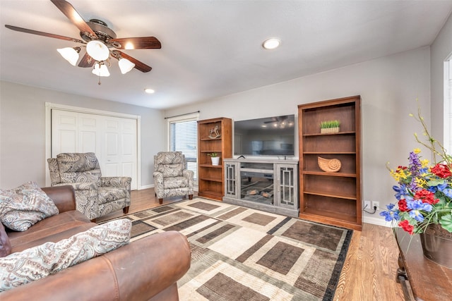 909 Coffield St, Bowie, TX 76230 - living area with a ceiling fan, wood finished floors, recessed lighting, and a fireplace