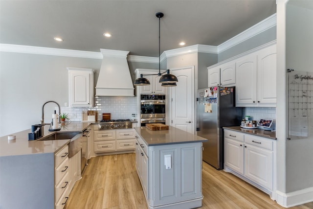 kitchen featuring dark countertops, appliances with stainless steel finishes, tasteful backsplash, and custom range hood
