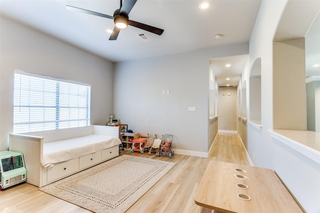 interior space with visible vents, a ceiling fan, wood finished floors, recessed lighting, and arched walkways