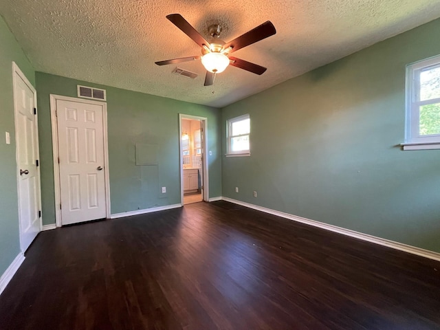 3408 Chaffin Dr, Richland Hills, TX 76118 - unfurnished bedroom with a textured ceiling, visible vents, and wood finished floors