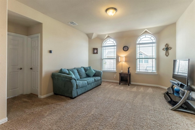 living area with visible vents, baseboards, and carpet flooring
