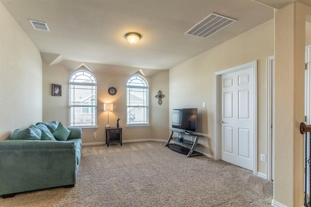 carpeted living area with baseboards and visible vents