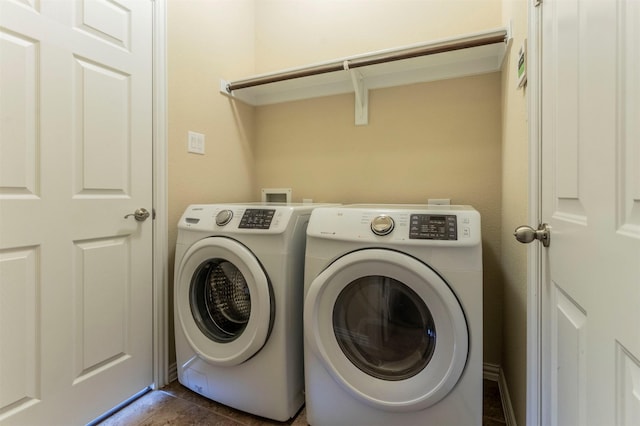 laundry area with washer and clothes dryer and laundry area