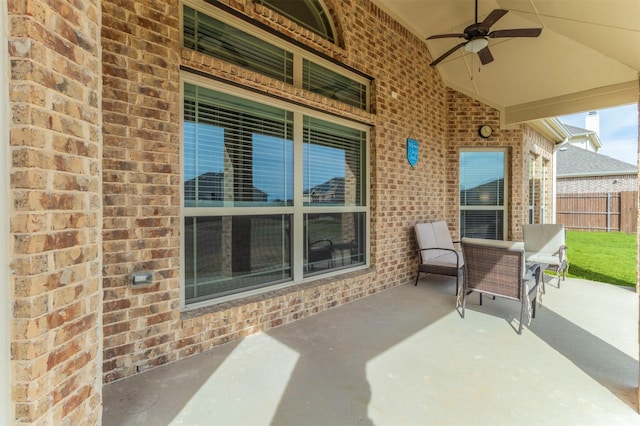 view of patio with a ceiling fan and fence
