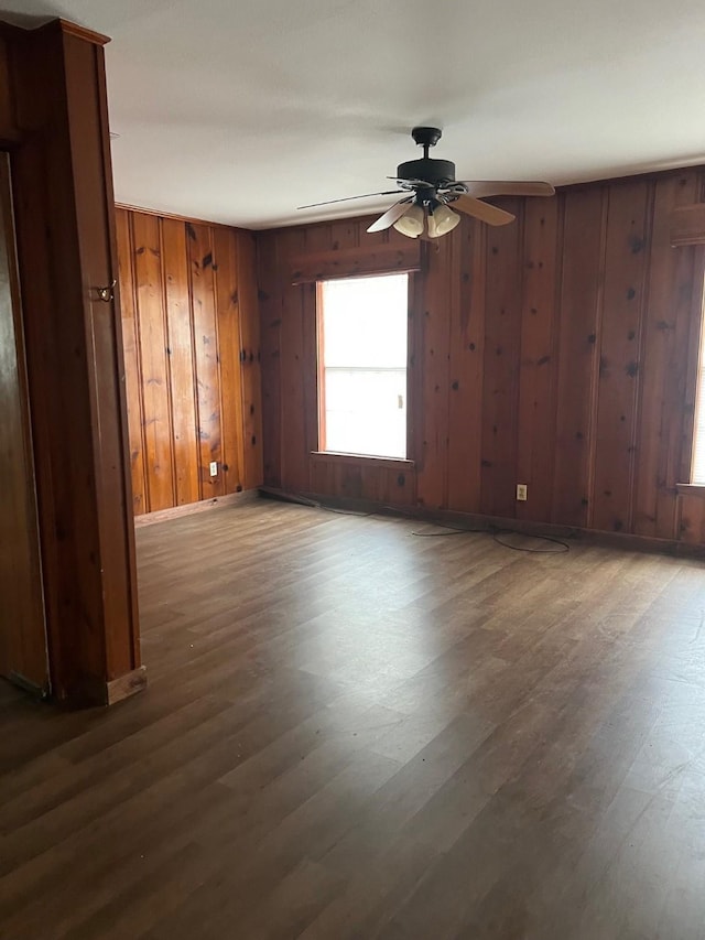 326 Hill Ave, Pittsburg, TX 75686 - unfurnished room featuring ceiling fan, wooden walls, wood finished floors, and baseboards