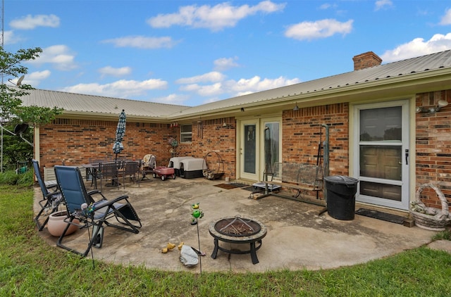 view of patio / terrace featuring an outdoor fire pit