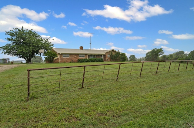 view of yard with a rural view and fence