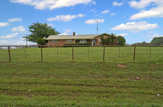 view of yard with a rural view and fence