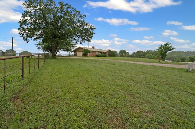 view of yard featuring fence and a rural view
