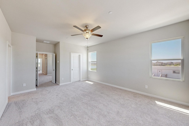 unfurnished bedroom with a ceiling fan, carpet flooring, and baseboards
